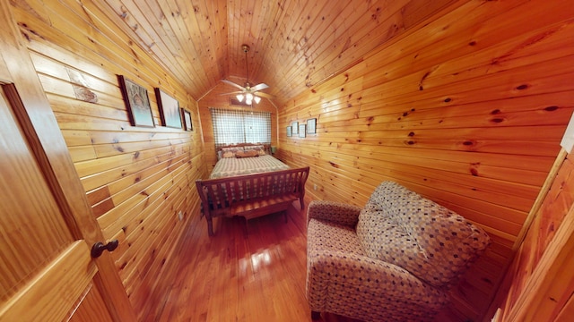 bedroom with wood walls, wood ceiling, lofted ceiling, and hardwood / wood-style flooring