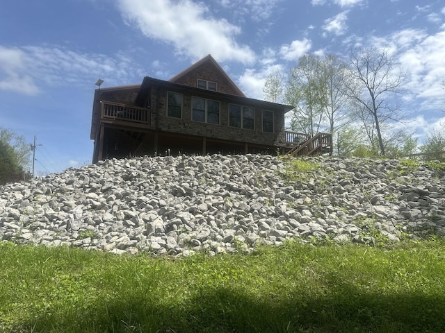 back of house with a deck