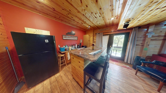 kitchen with french doors, wooden ceiling, freestanding refrigerator, a peninsula, and light wood-style flooring