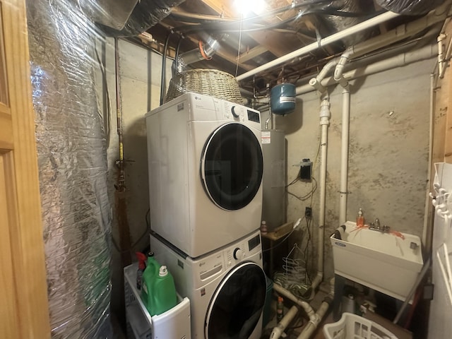 laundry room with a sink, stacked washer and clothes dryer, and laundry area