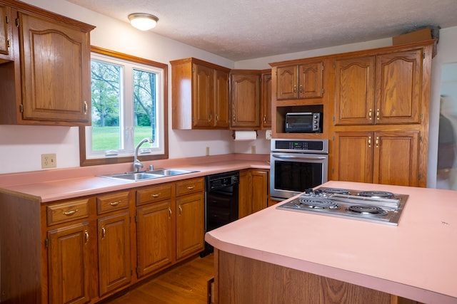 138 Hackett Pike, Richmond, KY 40475 - kitchen featuring black appliances, a sink, brown cabinetry, and light countertops