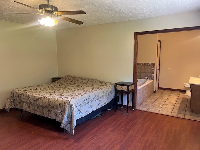 bedroom with a textured ceiling, ceiling fan, wood finished floors, and baseboards