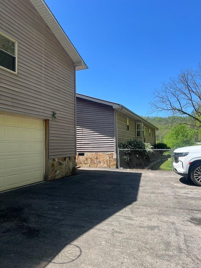 view of home's exterior with aphalt driveway
