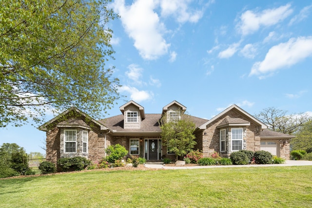 view of front of house featuring a front yard, roof with shingles, a garage, and brick siding