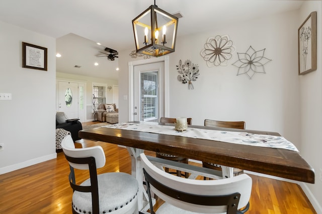 dining area with wood finished floors, recessed lighting, ceiling fan with notable chandelier, and baseboards