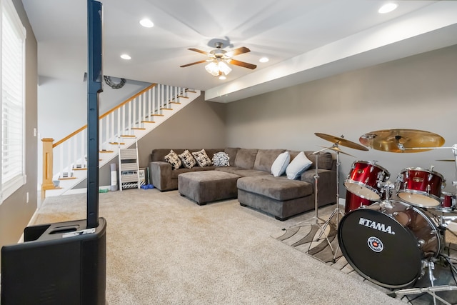 carpeted living room featuring a ceiling fan, recessed lighting, and stairs