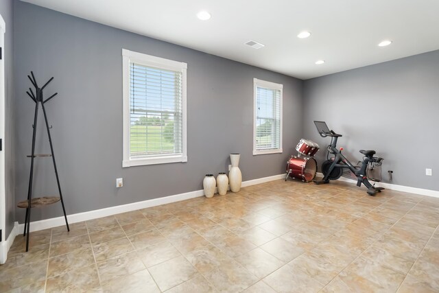 recreation room with baseboards, recessed lighting, light tile patterned floors, and a wealth of natural light