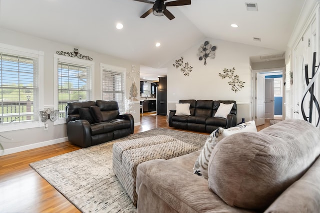 living area with visible vents, light wood-type flooring, recessed lighting, vaulted ceiling, and a ceiling fan