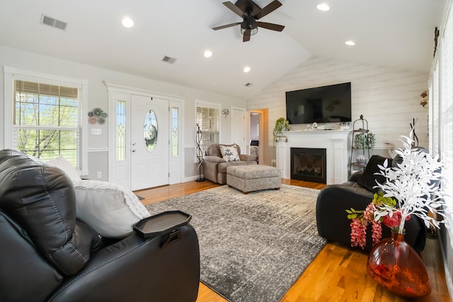 living room featuring a wealth of natural light, visible vents, and a ceiling fan