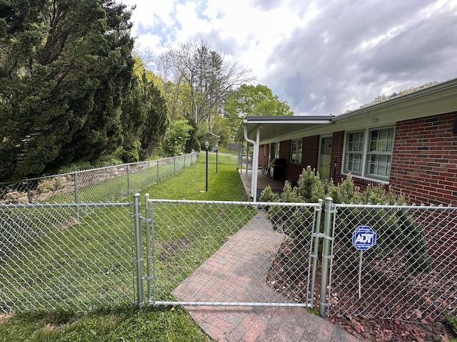 view of yard featuring fence and a gate