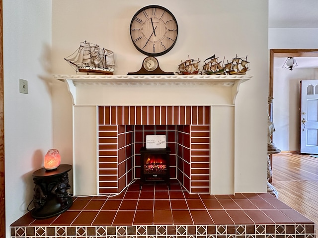 details with a tiled fireplace