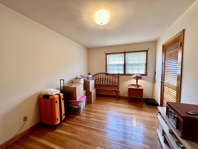 bedroom with baseboards and wood finished floors