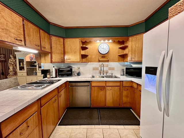 kitchen featuring a sink, open shelves, stainless steel appliances, and tile countertops