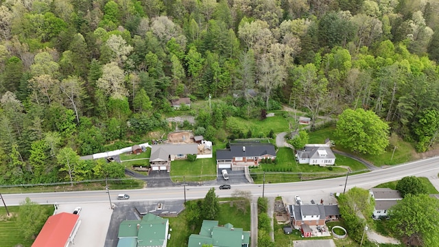 drone / aerial view with a residential view and a wooded view