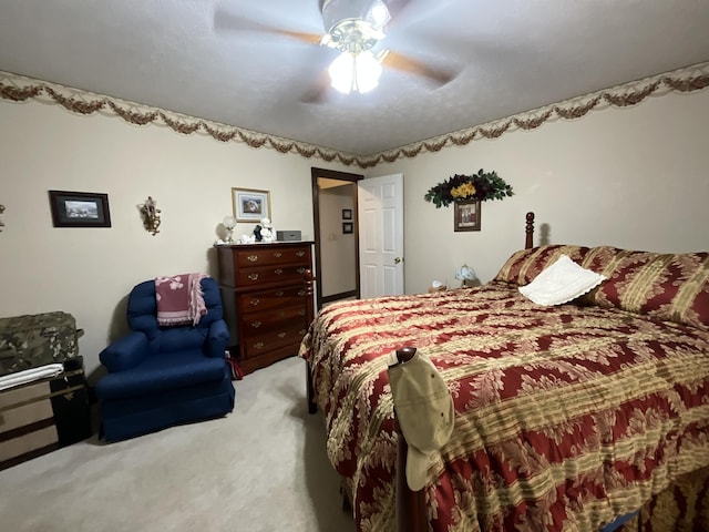 bedroom with ceiling fan and light carpet