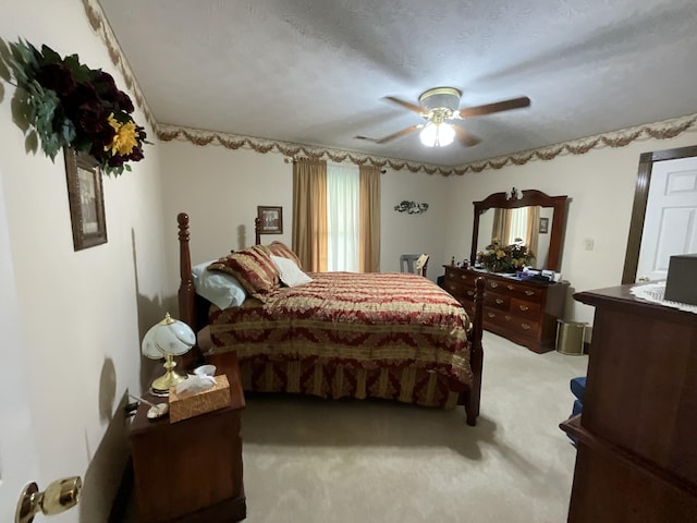 bedroom with light colored carpet and a ceiling fan