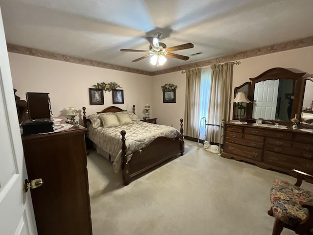 carpeted bedroom with visible vents and a ceiling fan