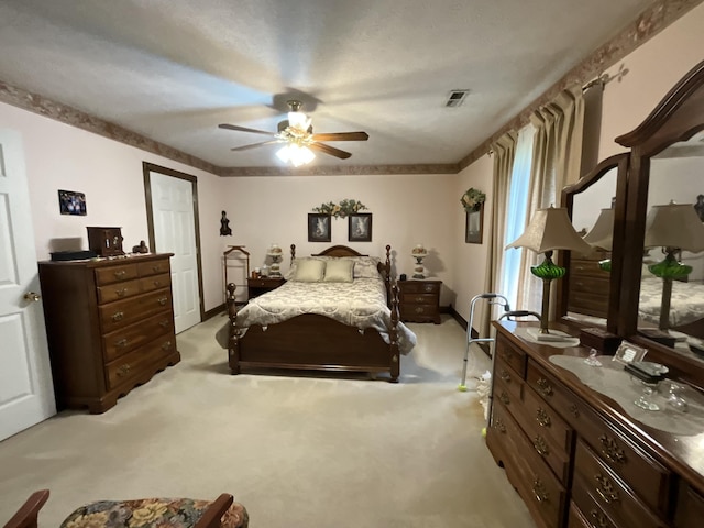 bedroom featuring light colored carpet and ceiling fan