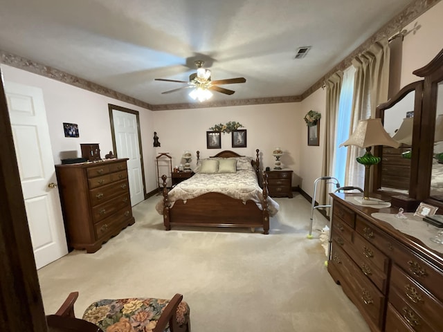bedroom featuring ceiling fan, light carpet, and baseboards
