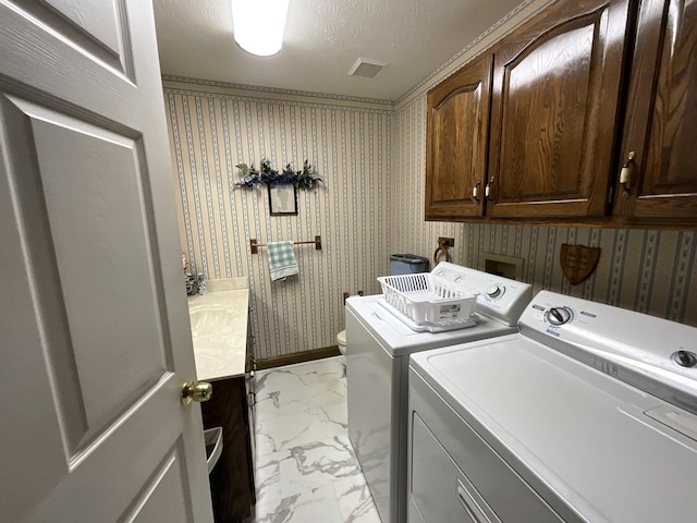 clothes washing area featuring marble finish floor, cabinet space, and independent washer and dryer