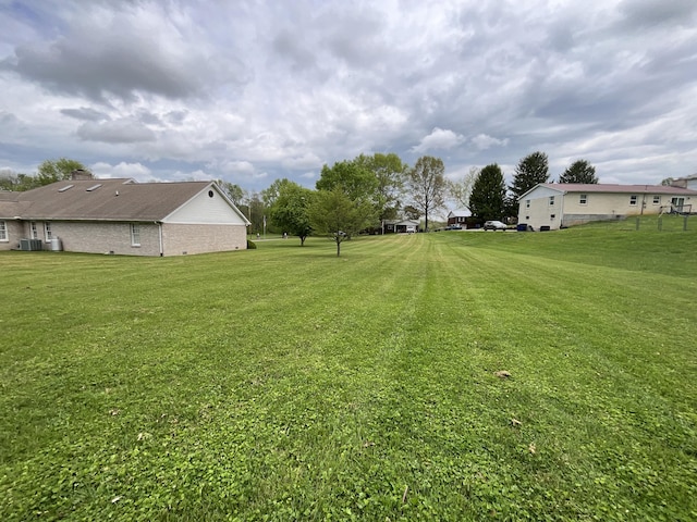 view of yard with central AC unit