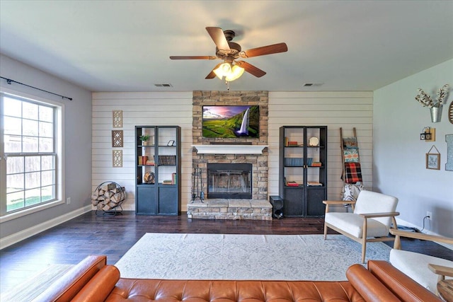 living area with visible vents, ceiling fan, and wood finished floors