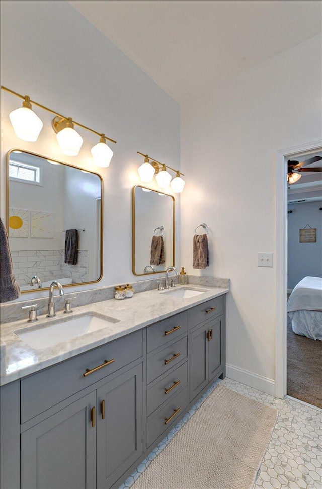 ensuite bathroom featuring a sink, double vanity, and connected bathroom