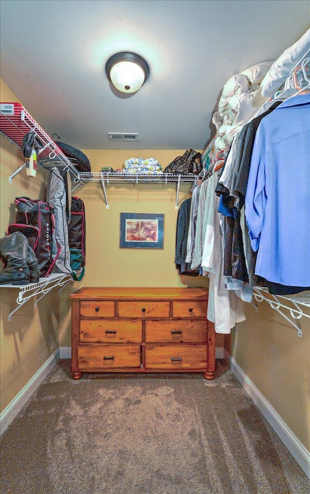 spacious closet with visible vents and dark carpet