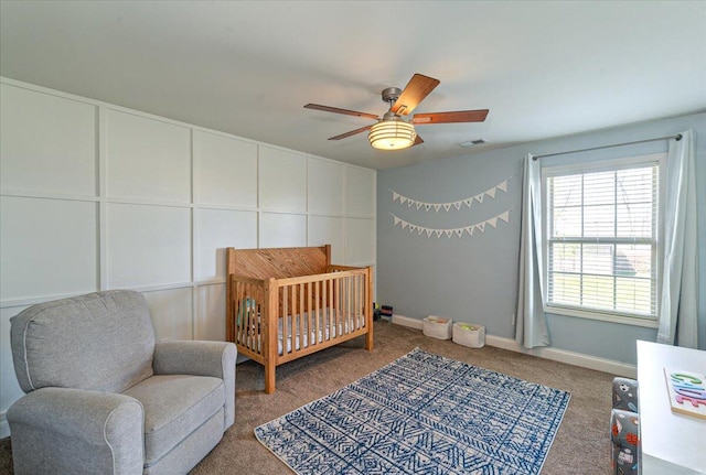 bedroom featuring visible vents, baseboards, carpet floors, and a nursery area
