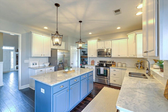 kitchen featuring a sink, white cabinets, a kitchen island, and stainless steel appliances