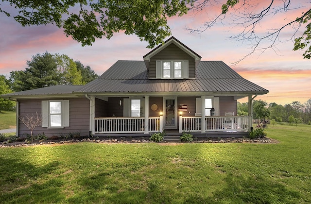 3576 Elkhorn Rd, Campbellsville, KY 42718 - country-style home featuring covered porch, metal roof, and a front yard