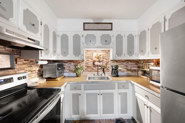 3576 Elkhorn Rd, Campbellsville, KY 42718 - kitchen with light countertops, under cabinet range hood, tasteful backsplash, a sink, and stainless steel appliances