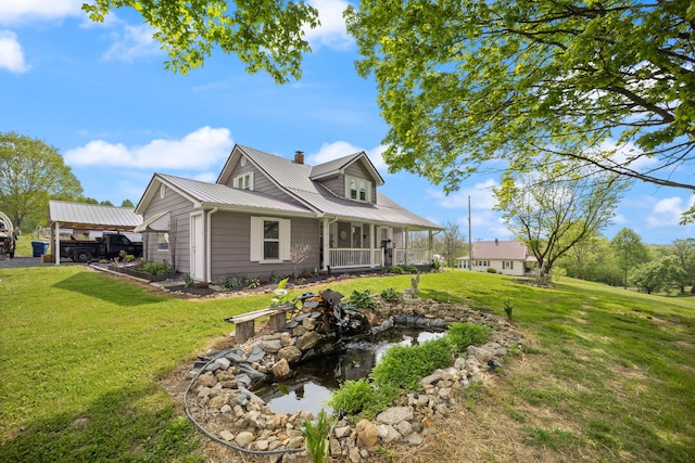 3576 Elkhorn Rd, Campbellsville, KY 42718 - exterior space with a garden pond, a yard, a chimney, and metal roof
