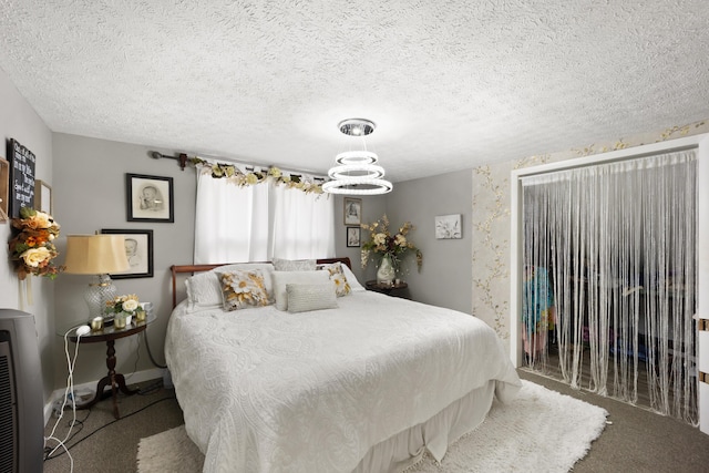 3576 Elkhorn Rd, Campbellsville, KY 42718 - bedroom with baseboards, a textured ceiling, carpet, and a notable chandelier