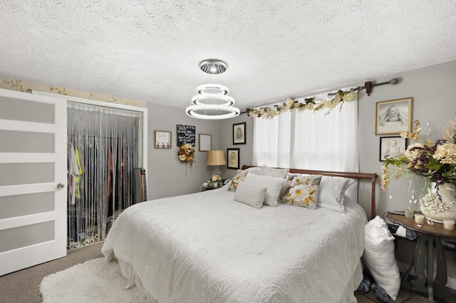 3576 Elkhorn Rd, Campbellsville, KY 42718 - carpeted bedroom featuring a textured ceiling and a chandelier