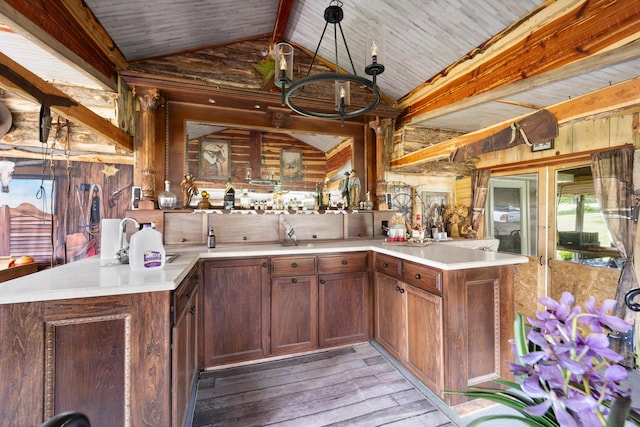 3576 Elkhorn Rd, Campbellsville, KY 42718 - kitchen featuring wooden walls, light countertops, a peninsula, light wood-type flooring, and vaulted ceiling