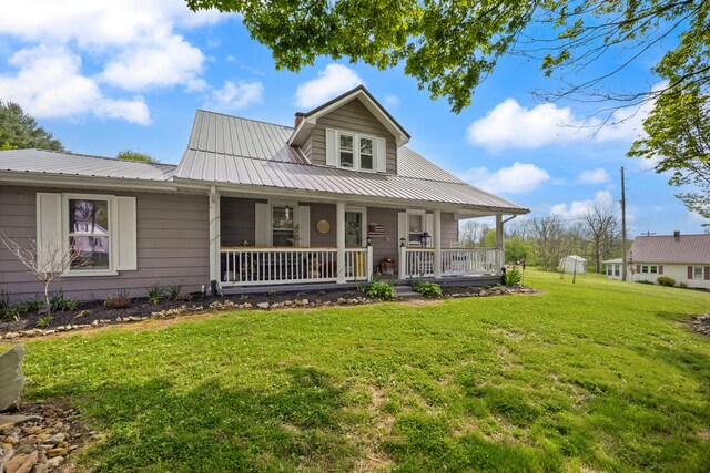 3576 Elkhorn Rd, Campbellsville, KY 42718 - farmhouse with a porch, metal roof, and a front yard