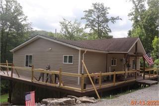 back of house with a wooden deck
