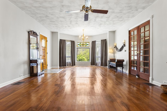 dining room with baseboards, visible vents, hardwood / wood-style flooring, and a textured ceiling