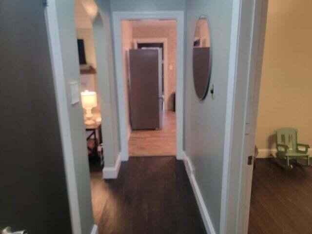 121 Hill Ct, Lancaster, KY 40444 - corridor featuring dark wood-style flooring, baseboards, and arched walkways