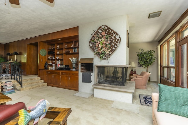 1964 Shadybrook Ln, Lexington, KY 40502 - living area with carpet floors, a fireplace, ceiling fan, and wooden walls