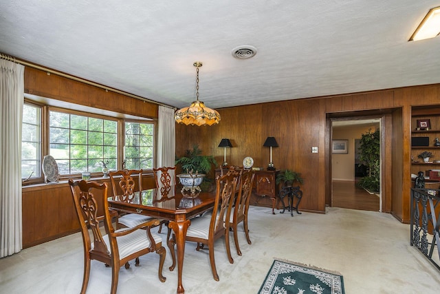 1964 Shadybrook Ln, Lexington, KY 40502 - dining space with wood walls, light colored carpet, and a textured ceiling