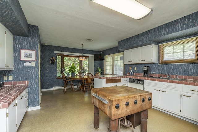 1964 Shadybrook Ln, Lexington, KY 40502 - kitchen featuring tile counters, wallpapered walls, white cabinetry, a baseboard radiator, and white dishwasher