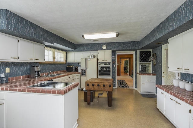 1964 Shadybrook Ln, Lexington, KY 40502 - kitchen with black oven, white fridge with ice dispenser, electric stovetop, tile countertops, and a sink