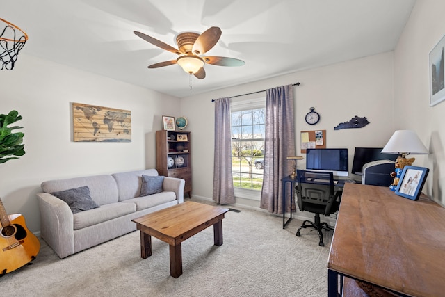 office space with ceiling fan and light colored carpet