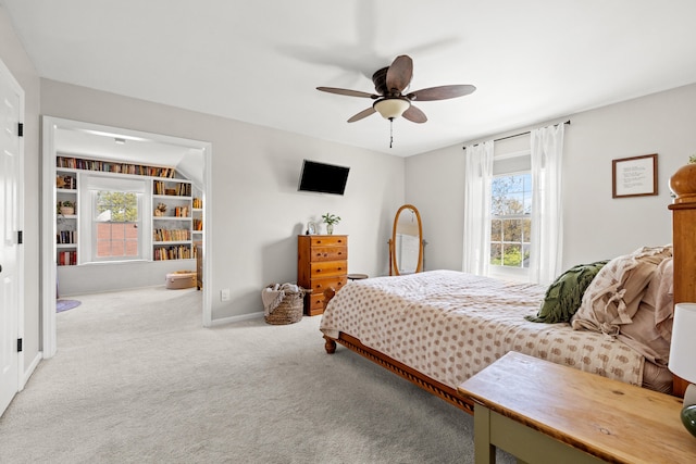 bedroom with a ceiling fan, baseboards, and carpet