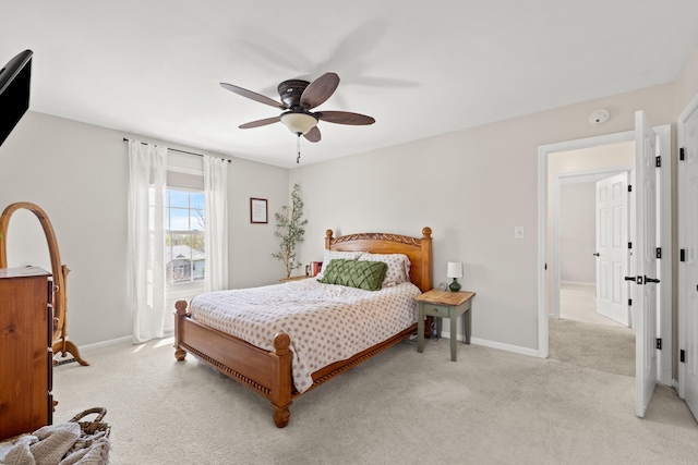 bedroom featuring a ceiling fan, baseboards, and light colored carpet