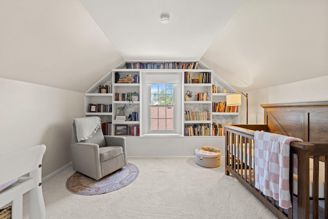 carpeted bedroom featuring a crib and vaulted ceiling