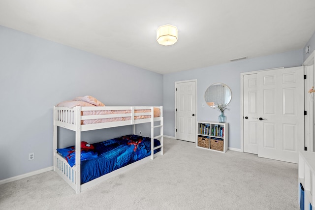 carpeted bedroom featuring baseboards and visible vents