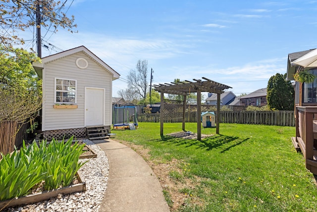 view of yard featuring a pergola, an outbuilding, a fenced backyard, and entry steps
